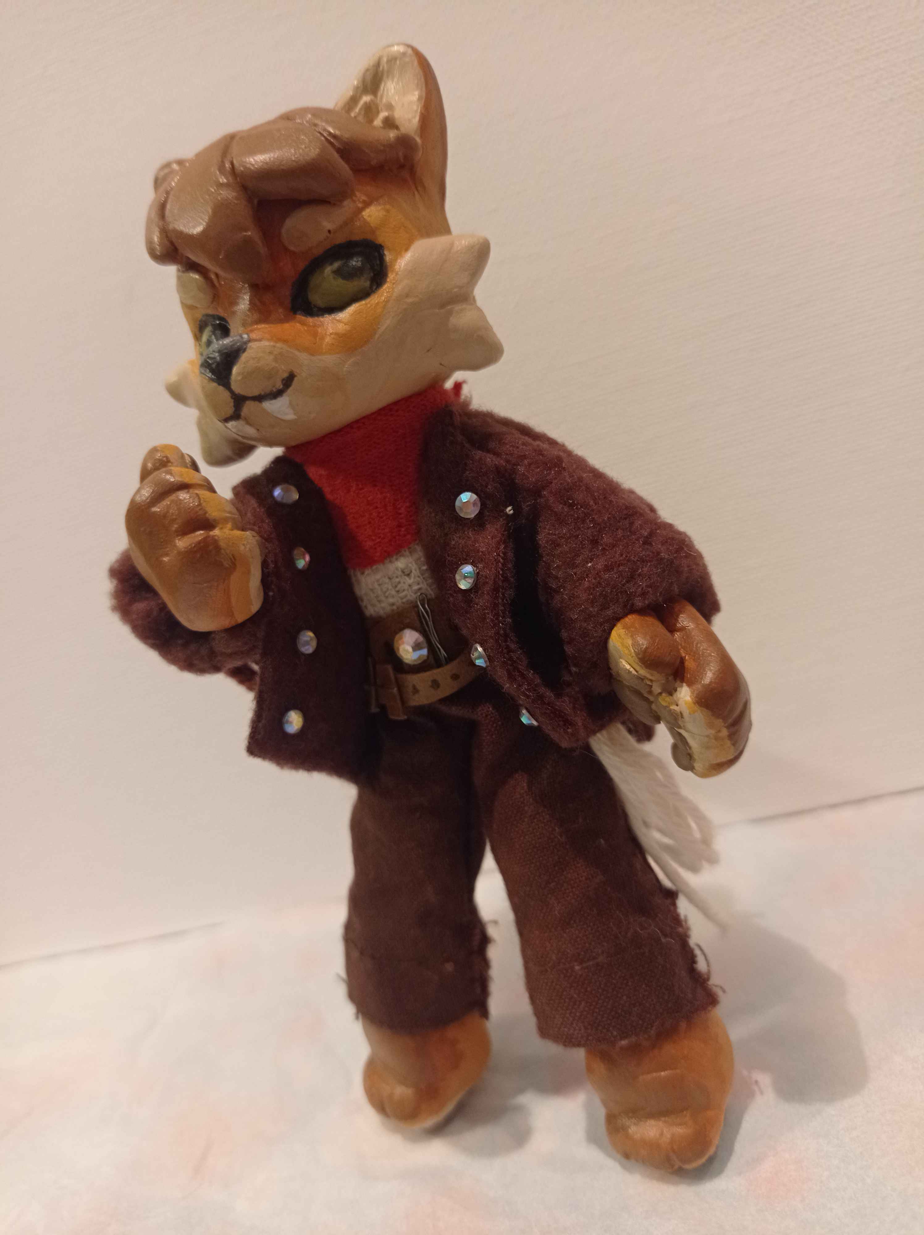 Sculpture of a cream colored anthropomorphic coyote standing